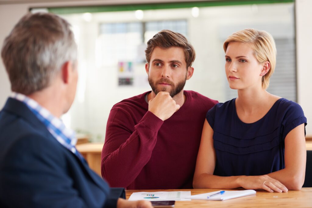Couple meeting with a financial adviser to discuss whether they need targeted support or regulated advice